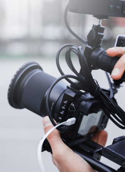 Freelance videographer recording a video using a camera