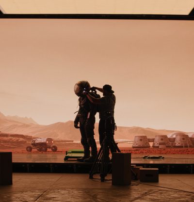 Crew filming on a virtual production set